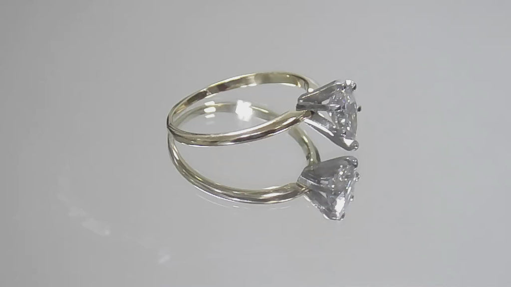 This is a video of a high quality 1.00ct natural pear shape diamond solitaire ring in yellow gold shown rotating slowly on a mirrored background.