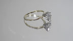 This is a video of a high quality 1.00ct natural pear shape diamond solitaire ring in yellow gold shown rotating slowly on a mirrored background.