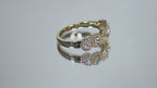 This is a multi shape natural diamond ring including a pea shape, round brilliant, emerald cut, princess cut and oval shape all surrounded by round diamond accents in 10K yellow gold rotating on a mirrored surface in a video.