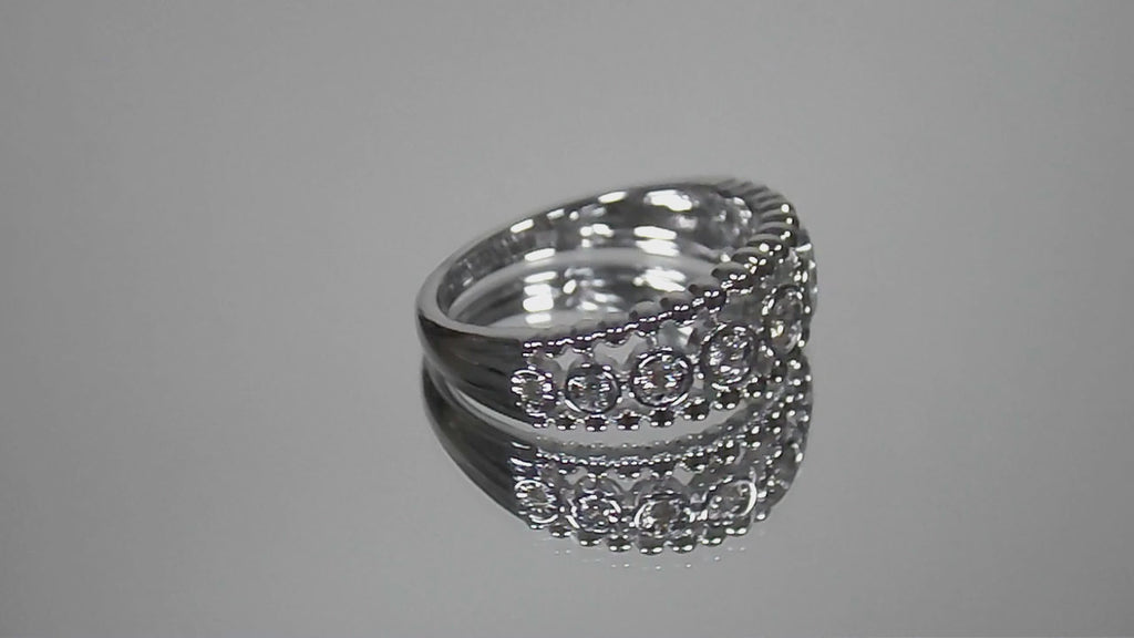 .20ct bezel set natural round brilliant diamond ring in 10K white gold rotating in a video on a mirrored background.