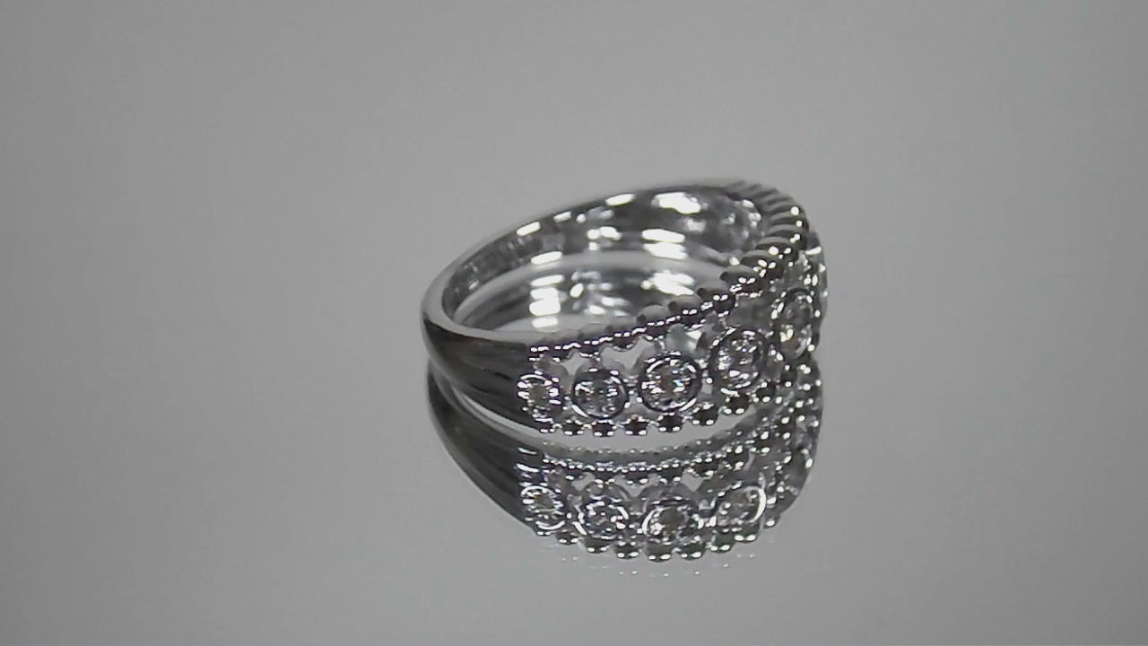 .20ct bezel set natural round brilliant diamond ring in 10K white gold rotating in a video on a mirrored background.