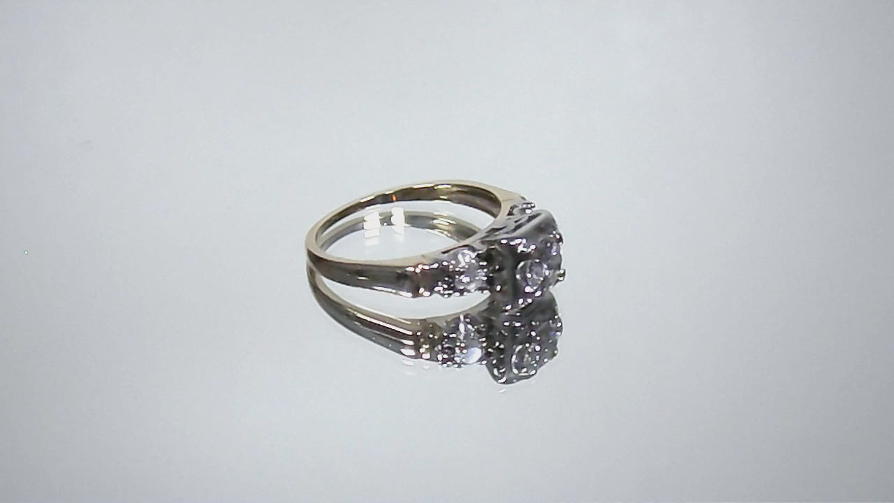 This is a video of a Vintage .59ct ladies natural diamond wedding ring in yellow gold turning slowly on mirrored background.