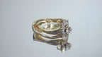 This is a custom 2-piece set with a matching band .77ct total weight with .25ct center round brilliant diamond in 14K yellow gold on a mirrored background rotating in a video.