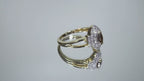 .50ct total weight with chocolate marquise center diamond and white round diamond accents in 2-tone white and yellow gold rotating in a video on a white background.