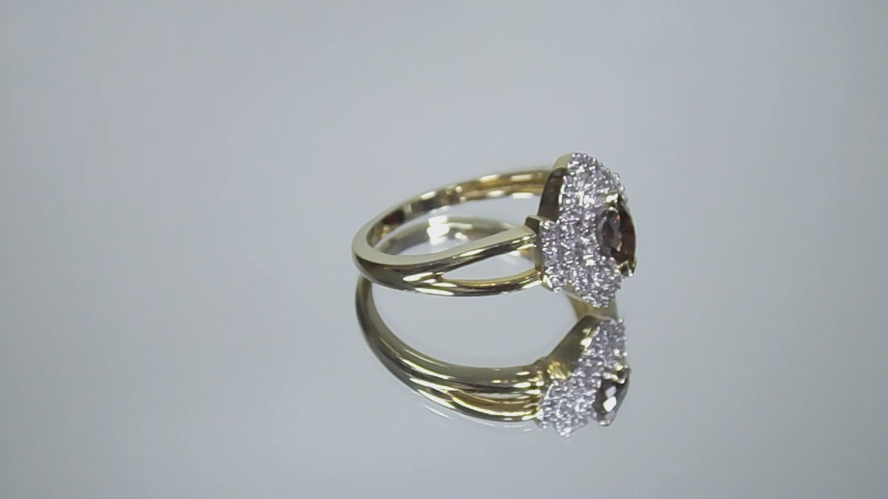 .50ct total weight with chocolate marquise center diamond and white round diamond accents in 2-tone white and yellow gold rotating in a video on a white background.