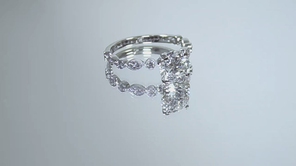 This is a video of a women's 1.72ct total weight natural round diamond engagement ring in white gold rotating with black mirrored background.