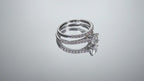 This is a video of a natural oval shape diamond wedding set ring with matching band in white gold shown turning slowly on a mirrored backgound.