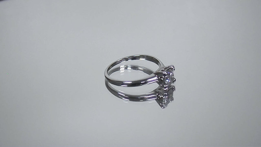 This is a video of an estate .45ct round diamond solitaire ring in white gold shown turning slowly on a mirrored background.