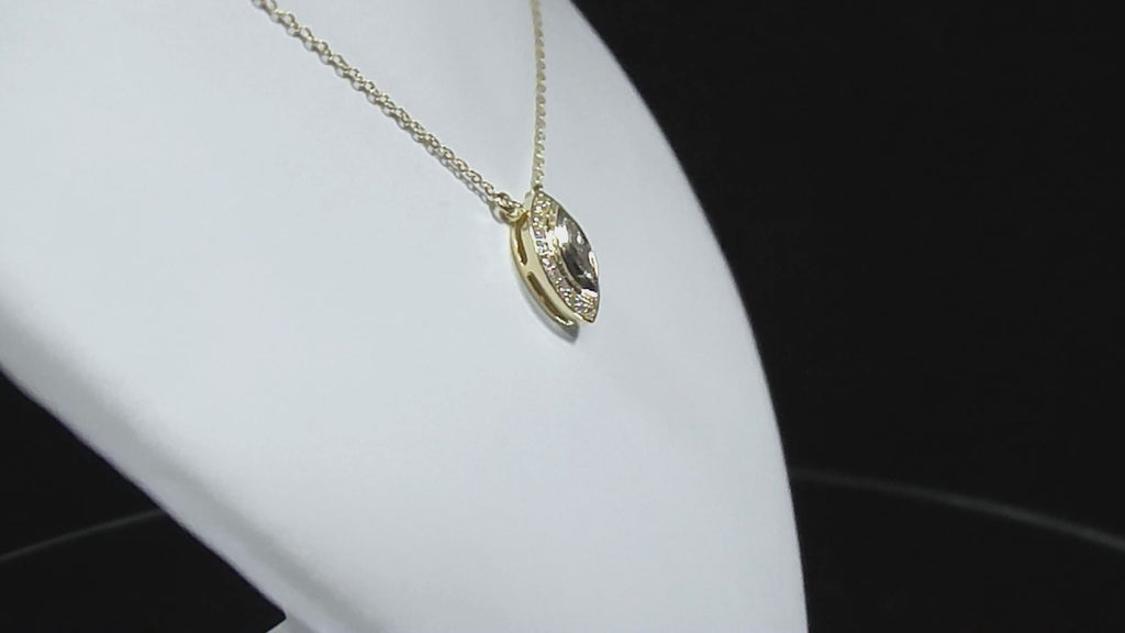This is a .25ct natural center marquise diamond necklace with a halo of .10ct round diamonds in 14K yellow gold in a rotating video on a white display neck.