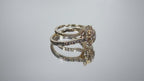 This is a video of a 2-Piece yellow gold and diamond wedding set ring with matching band turning slowly with mirrored background.