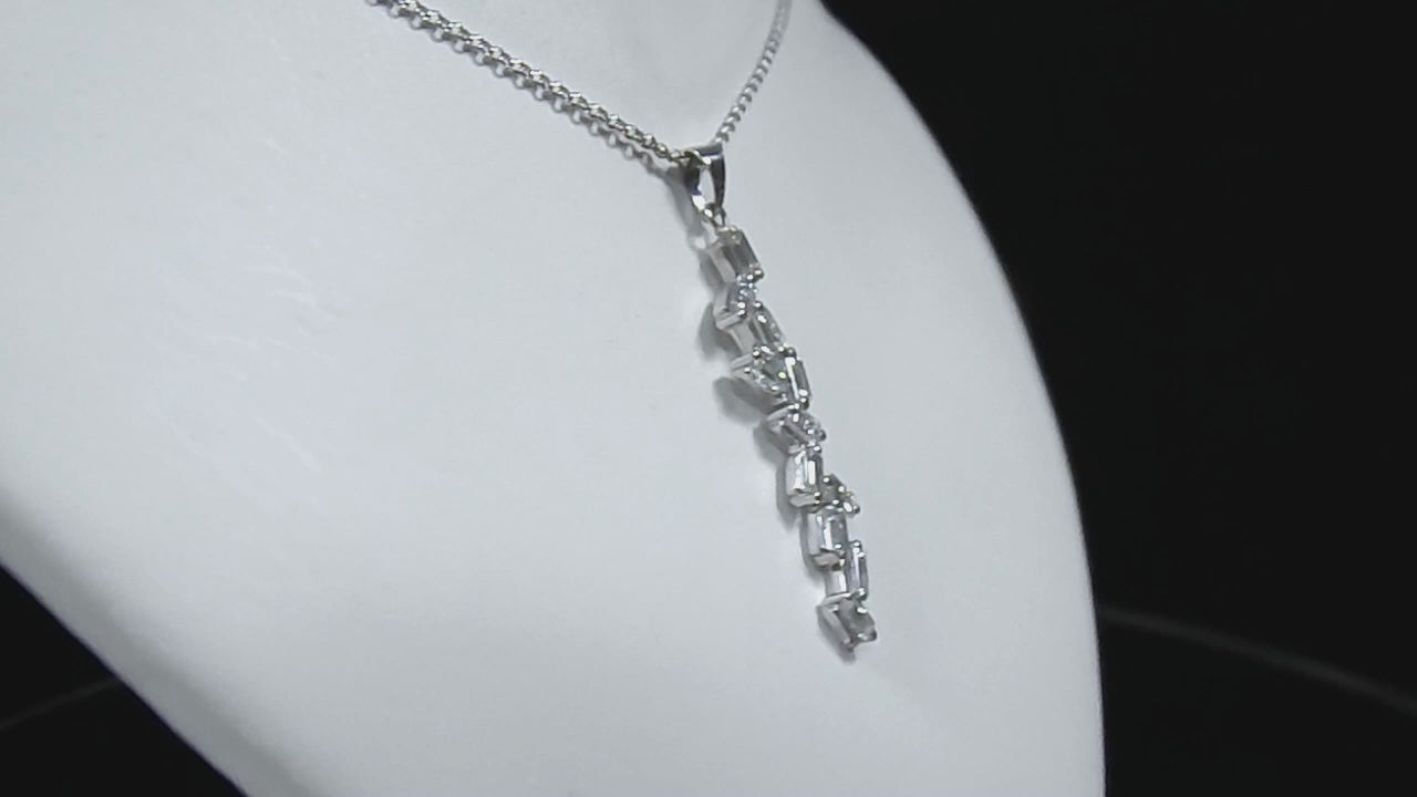This is a custom made .91ct natural baguette diamond necklace in 18K white gold rotating on a white neck in a video.