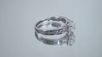 This is a video of a halo style .50ct total weight natural princess cut diamond ring in white gold turning slowly on a mirrored background.