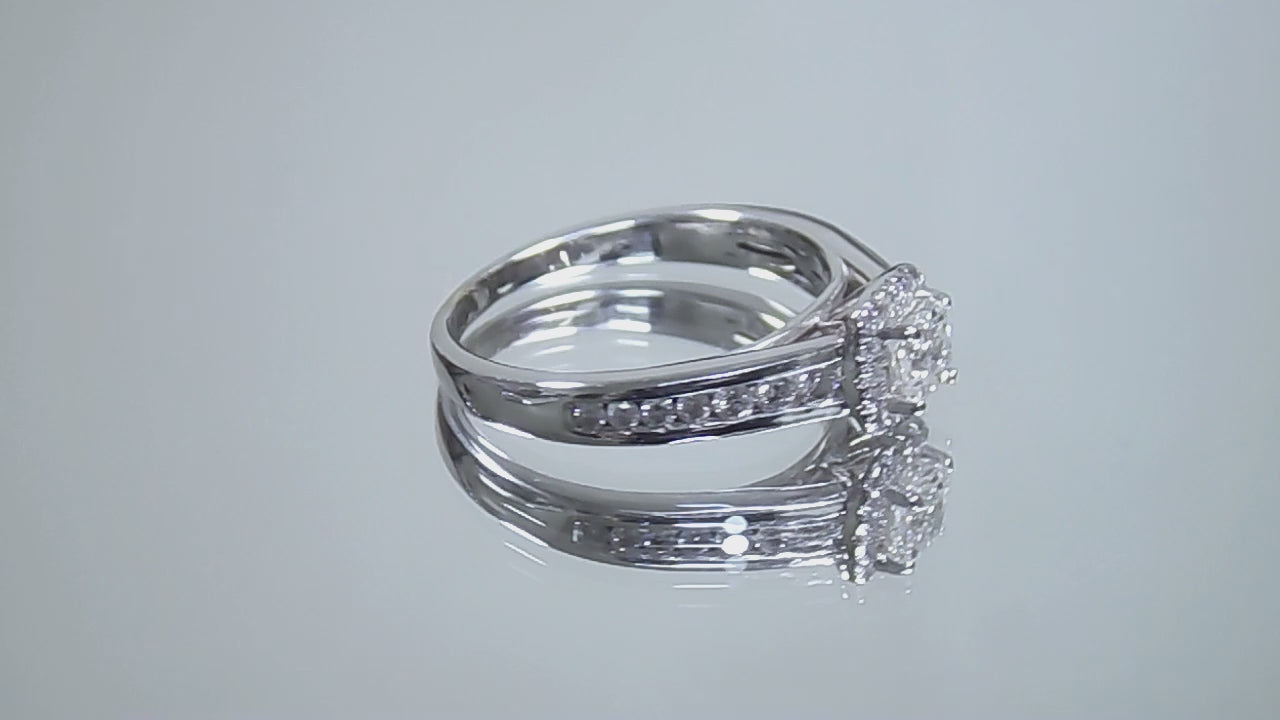This is a video of a halo style .50ct total weight natural princess cut diamond ring in white gold turning slowly on a mirrored background.