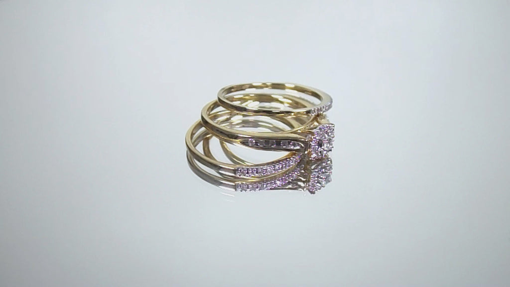 This is a video of a halo style 2-piece diamond wedding set with 2 matching bands in yellow gold shown turning slowly with mirrored background