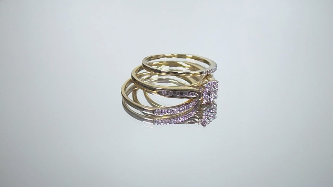This is a video of a halo style 2-piece diamond wedding set with 2 matching bands in yellow gold shown turning slowly with mirrored background