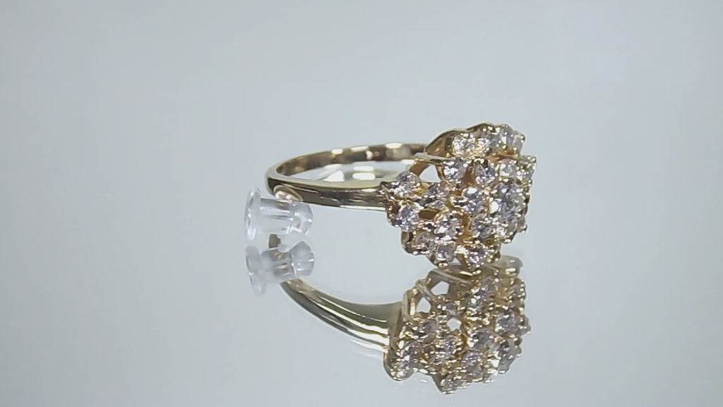 This is 1.20ct total weight natural diamond cluster cocktail ring in 14K yellow gold on a mirrored background rotating in a video.