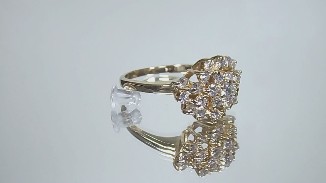 This is 1.20ct total weight natural diamond cluster cocktail ring in 14K yellow gold on a mirrored background rotating in a video.