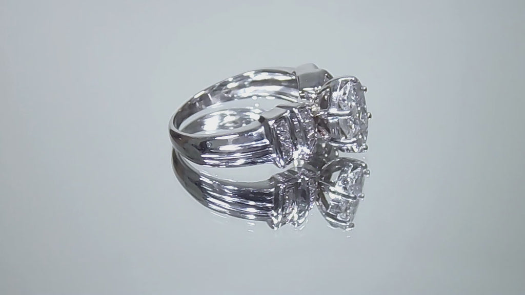 This is a video of a 1.50ct total weight natural diamond ring in white gold from our estate collection shown slowly turning on a mirrored background.