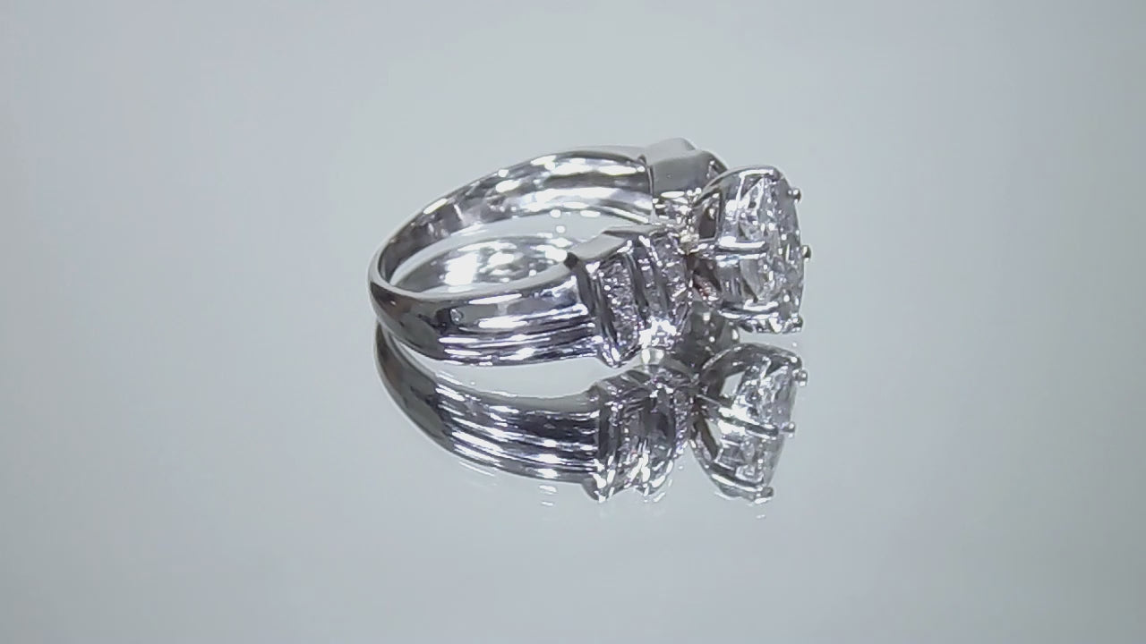 This is a video of a 1.50ct total weight natural diamond ring in white gold from our estate collection shown slowly turning on a mirrored background.