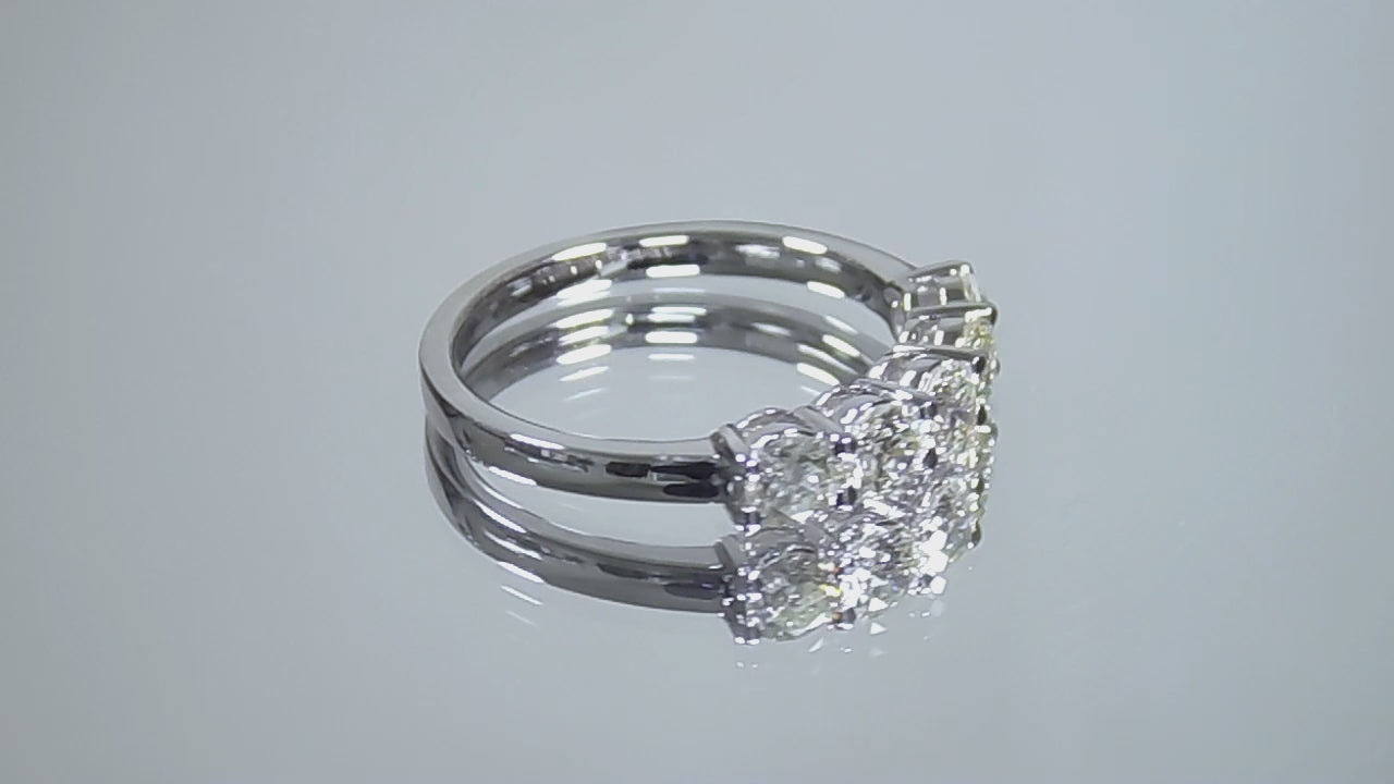 This is a video of a 5-Stone natural diamond band in white gold turning slowly on mirrored background.