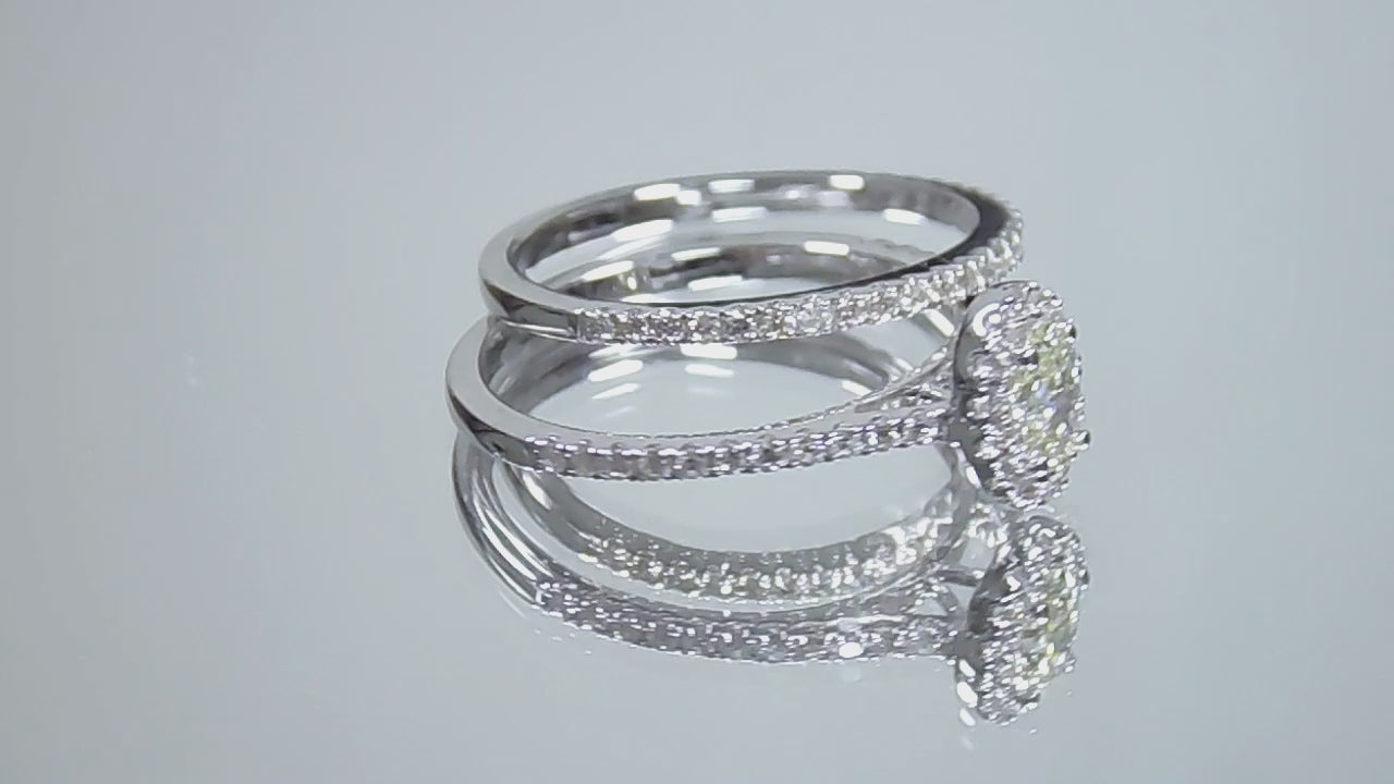 This is a video of a .73ct total weight 2-piece halo style oval shape natural diamond wedding set with engagement ring and matching band shown turning slowly on a mirrored background.