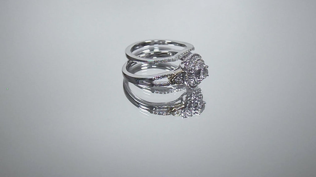 This is video of a halo style 2-piece wedding set ring with matching band in white gold with yellow gold accents shown turning slowly on mirrored background.