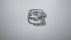 This is video of a halo style 2-piece wedding set ring with matching band in white gold with yellow gold accents shown turning slowly on mirrored background.