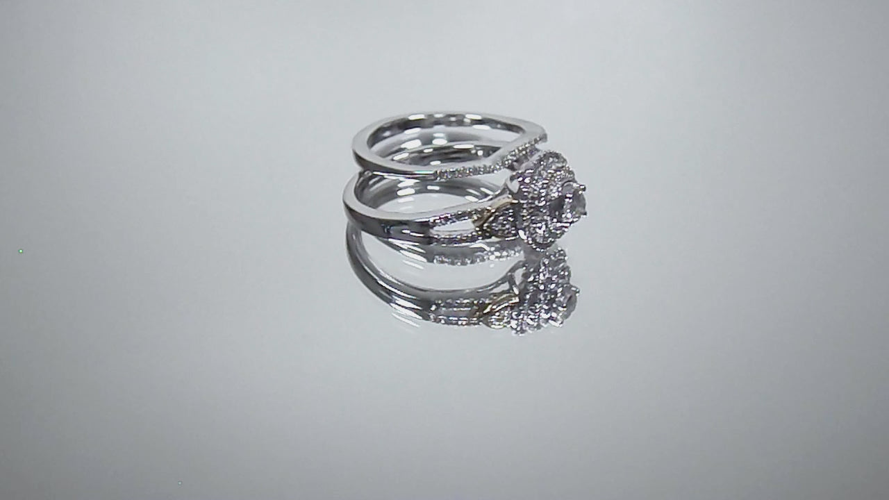 This is video of a halo style 2-piece wedding set ring with matching band in white gold with yellow gold accents shown turning slowly on mirrored background.