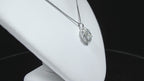 This is a 2.00ct natural round halo style diamond necklace with a 1.00ct center round brilliant diamond and 1.00ct round brilliant diamonds in the halo in 14K white gold on a white neck rotating in a video.