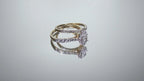 This is a video of a 2-piece natural oval shape diamond wedding set weighing 1ct total with both the engagement ring and matching band in yellow gold with white gold prongs shown turning slowly on a mirrored backgrouond.