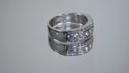 This is a video of a 3-row channel & prong set 1.00ct total weight natural wide diamond band in white gold turning slowly on a mirrored background.