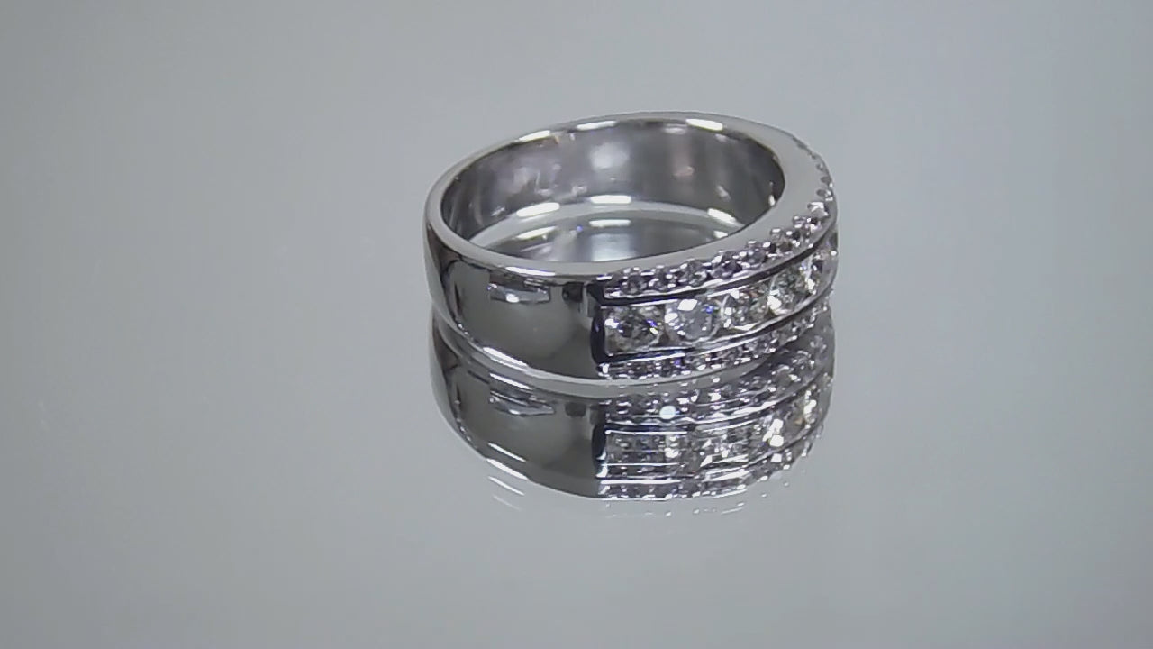 This is a video of a 3-row channel & prong set 1.00ct total weight natural wide diamond band in white gold turning slowly on a mirrored background.