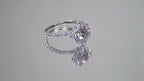 This is a video of a 1.25ct total weight natural diamond ring with a .84ct natural round brilliant diamond in the center in white gold shown rotating on a mirrored background.