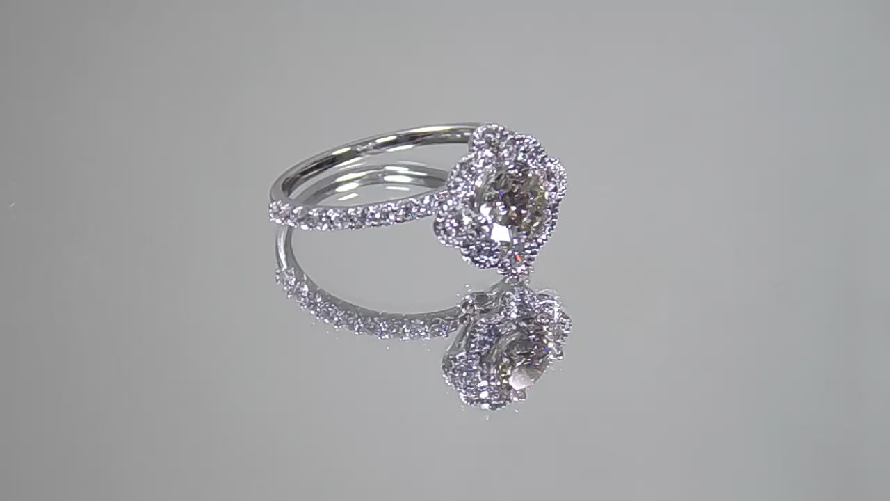 This is a video of a 1.25ct total weight natural diamond ring with a .84ct natural round brilliant diamond in the center in white gold shown rotating on a mirrored background.