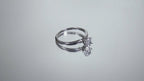 This is a video of a white gold natural oval shape diamond solitaire turning on a mirrored background.