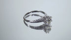 This a video of an antique women's solitaire ring from the 1880's with a natural old mine cut center shown turning slowly on a mirrored background.