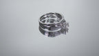 This is a video of a two piece diamond wedding set with the ring and matching band in white gold shown turning slowly on mirrored background.