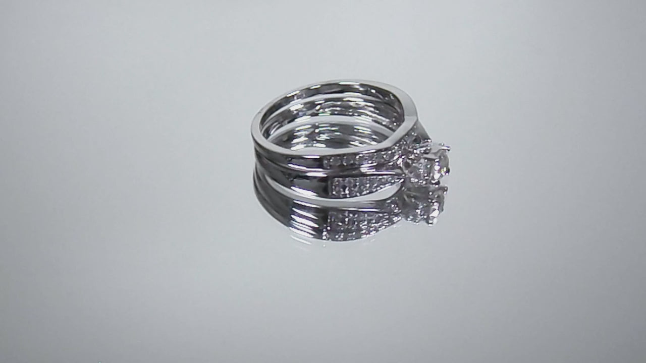 This is a video of a two piece diamond wedding set with the ring and matching band in white gold shown turning slowly on mirrored background.
