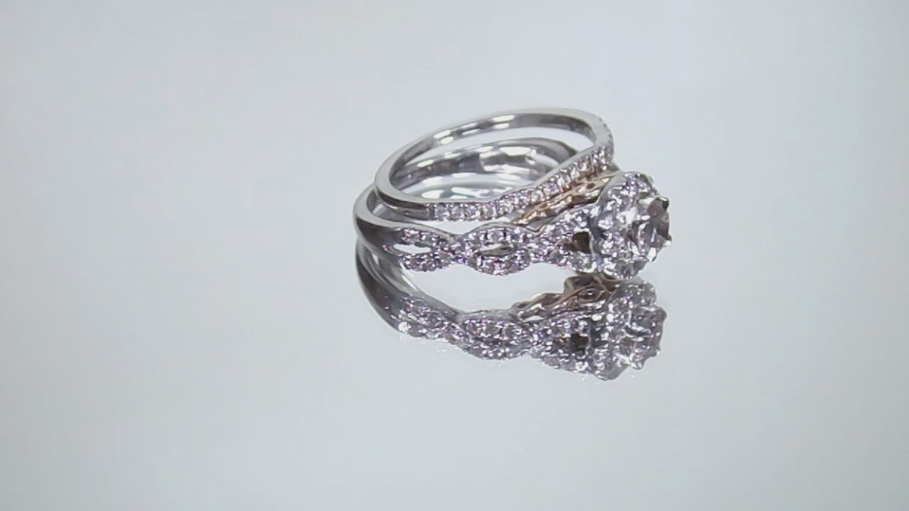 This is a video of a women's 2-piece wedding set which includes the engagement ring and matching band weighing 1.02ct in natural diamonds in white gold with rose gold accents on a mirrored background
