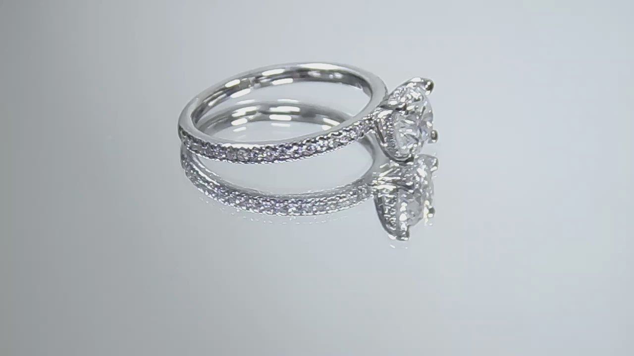 This is a video of a straight line style 1.39ct total weight natural round brilliant diamond ring in white gold shown rotating slowly on mirrored background.