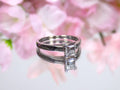 This is a natural diamond princess cut solitaire engagement ring in white gold with floral background. 