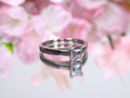 This is a natural diamond princess cut solitaire engagement ring in white gold with floral background. 