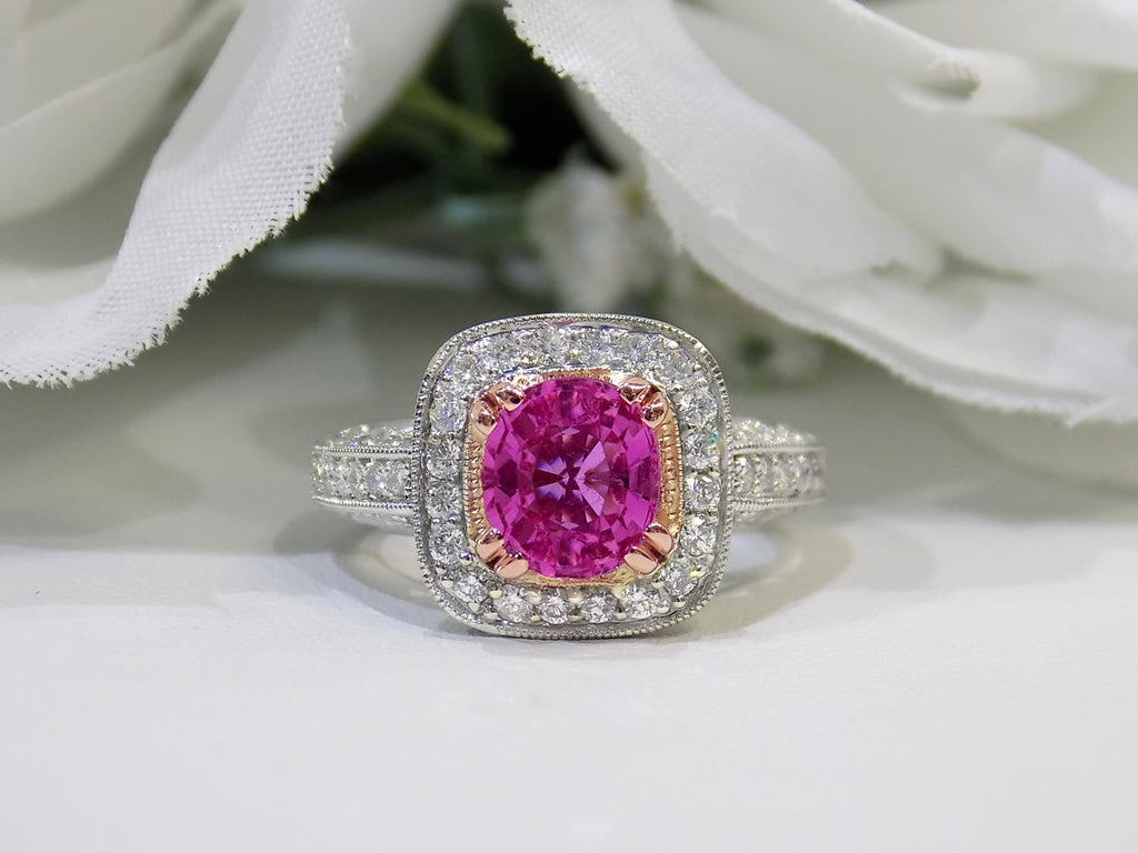 This is a women's ring with a natural 2.21ct pink sapphire in the center with a total weight of .86ct natural round diamond accents set in 18K white and yellow gold with a white floral background.