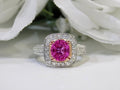 This is a women's ring with a natural 2.21ct pink sapphire in the center with a total weight of .86ct natural round diamond accents set in 18K white and yellow gold with a white floral background.