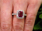 This is a women's ring with a 1.47ct natural emerald cut pink tourmaline surrounded by .67ct natural round diamonds set in 14K white gold on a women's finger.