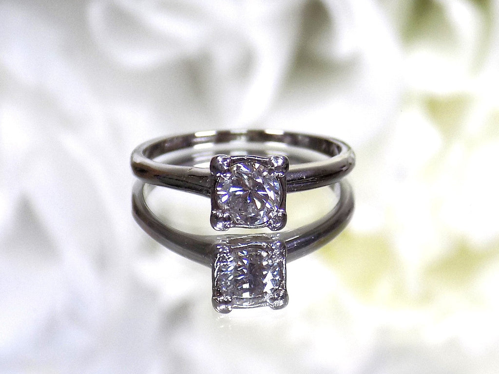 This is an estate .45ct round diamond solitaire ring in white gold with a white background.