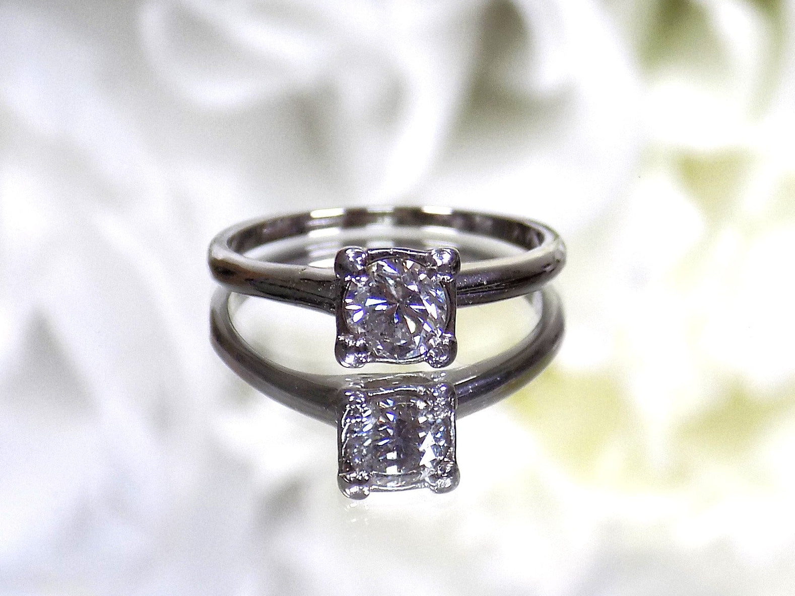 This is an estate .45ct round diamond solitaire ring in white gold with a white background.
