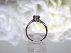 This is an estate .45ct round diamond solitaire ring in white gold shown from the side with a white background.
