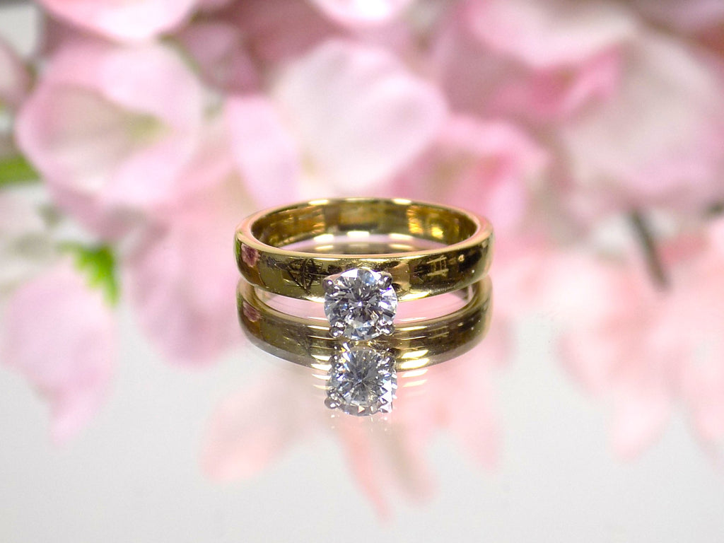 This is .45ct natural round brilliant solitaire ring on wider yellow gold band with floral background.
