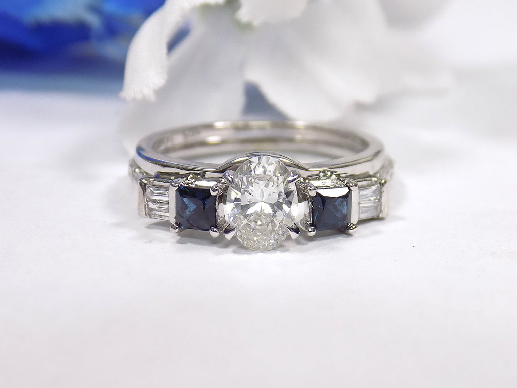 This is a white gold sapphire and diamond ring guard or wrap shown with an oval solitaire placed in the center.